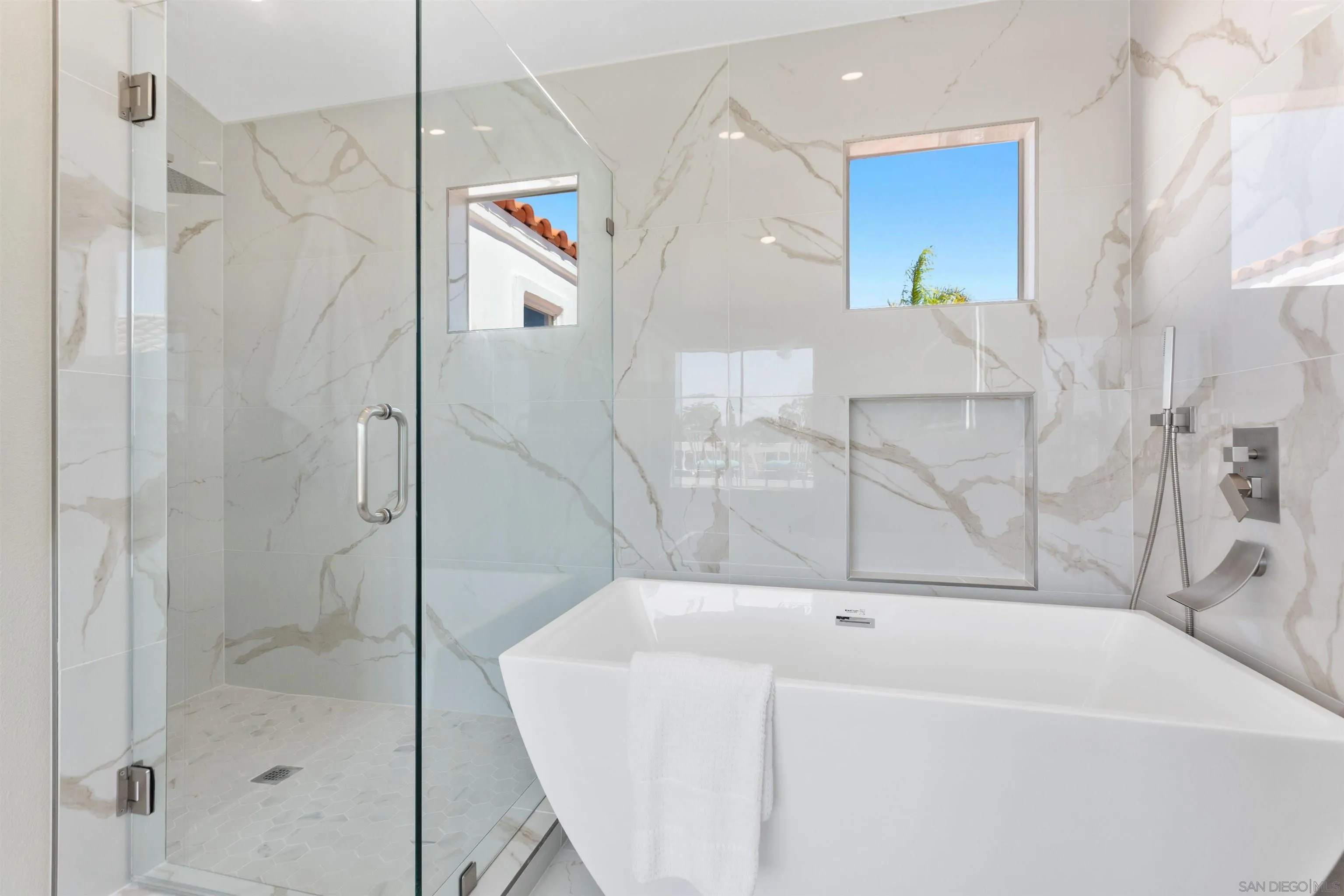 4963 Pylos Way Oceanside, CA 92056 - Photo 31 of 53 a bathroom with a bathtub and a shower