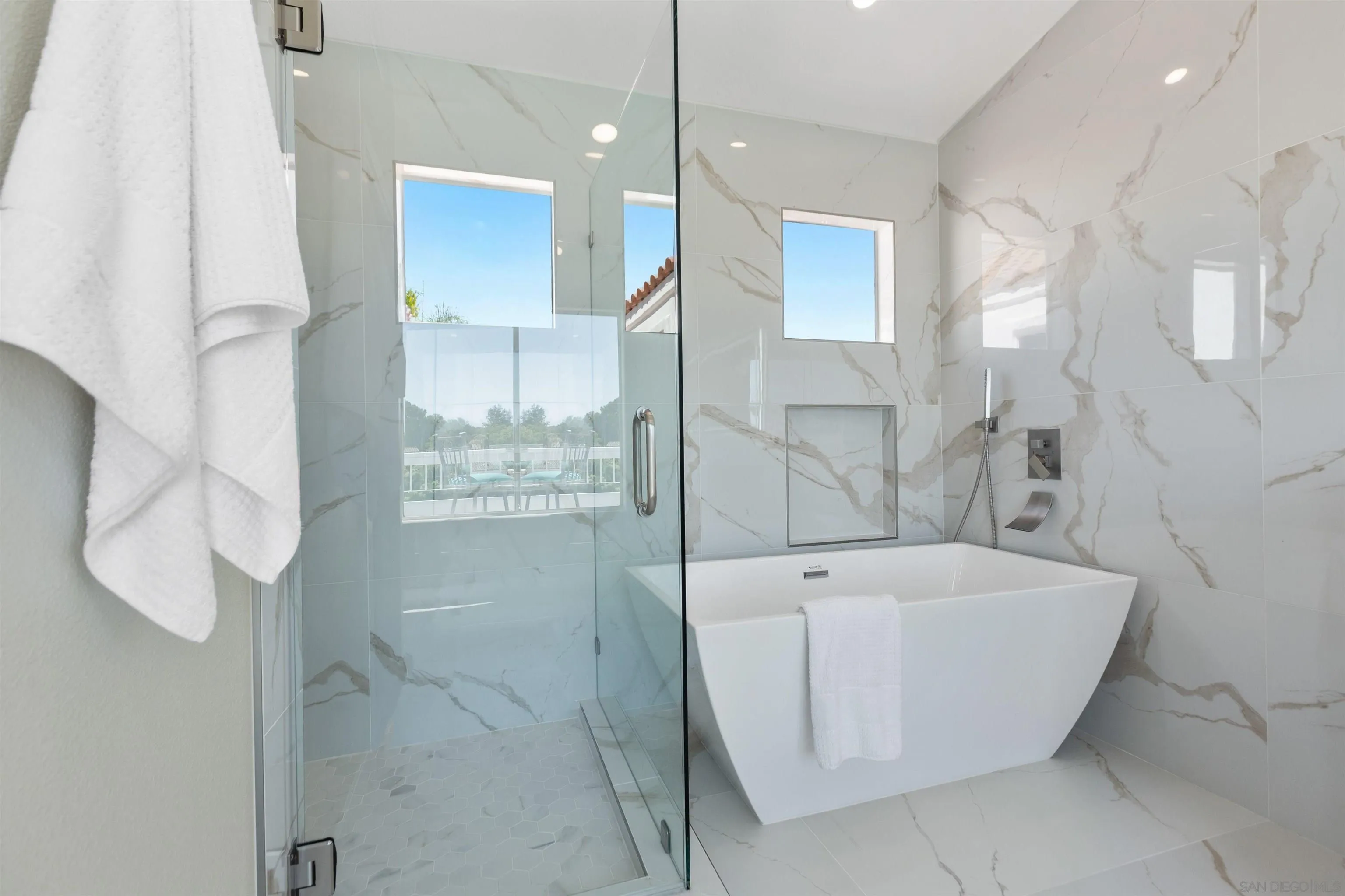 4963 Pylos Way Oceanside, CA 92056 - Photo 32 of 53 a bathroom with a bathtub and shower