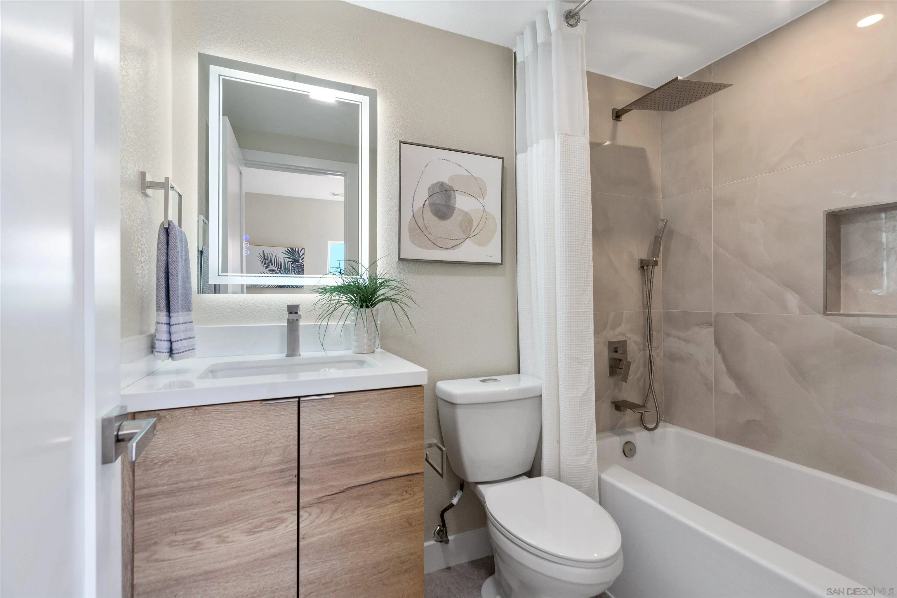 4963 Pylos Way Oceanside, CA 92056 - Photo 42 of 53 a bathroom with a toilet a sink and a bathtub