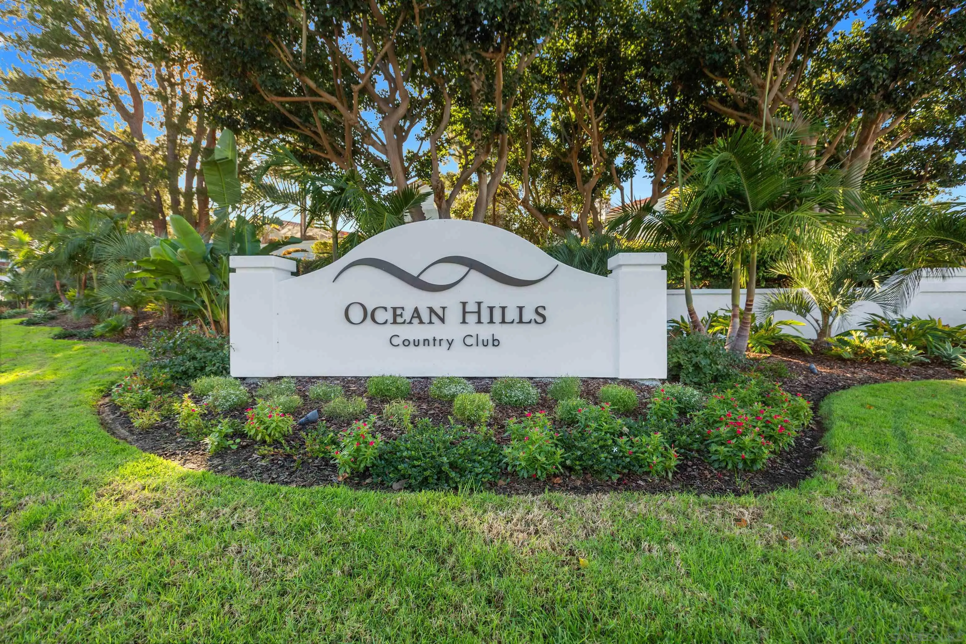 4963 Pylos Way Oceanside, CA 92056 - Photo 45 of 53 a sign of golf club on a wall under a tree