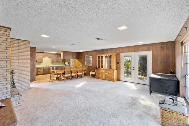a view of a livingroom with lounge chair and a large window
