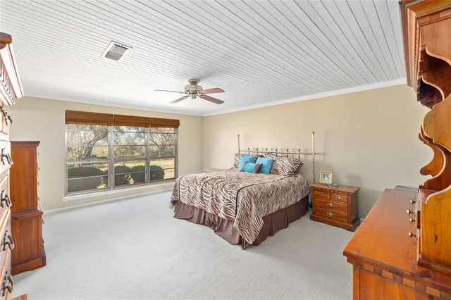 a spacious bedroom with a bed and window