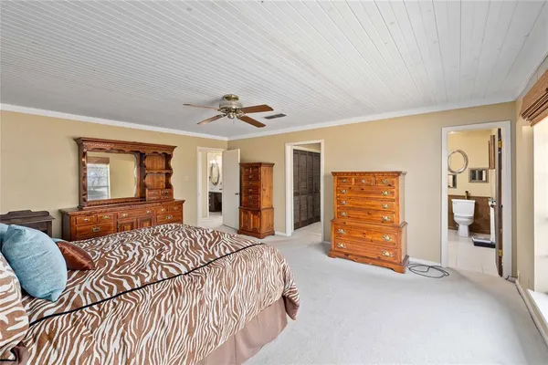 a bedroom with a large bed closet and flat tv screen