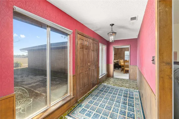 a hallway with a glass door and shower
