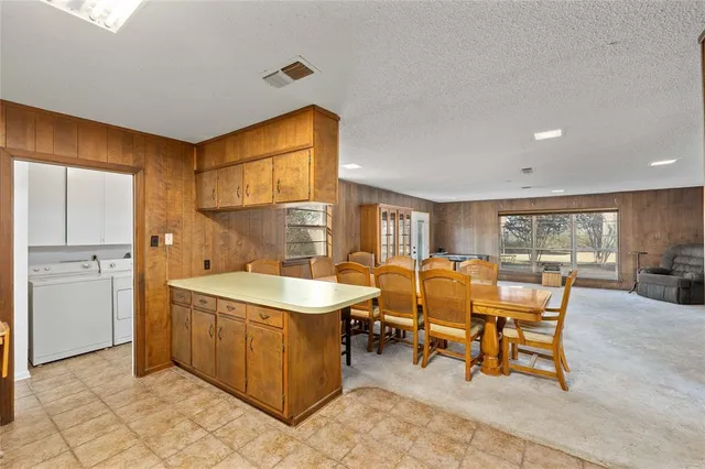 a living room with a sink and a dining table