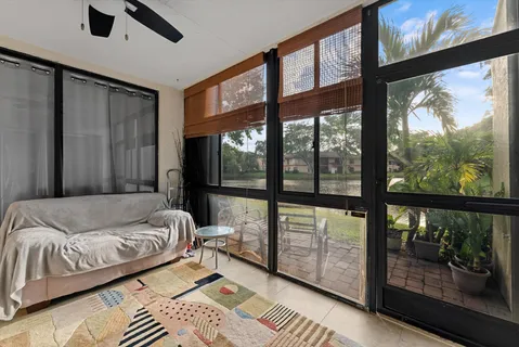 a living room with a bed couch and a large window