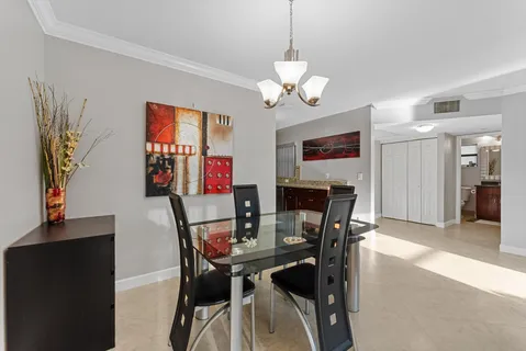 a view of a dining room with furniture and chandelier
