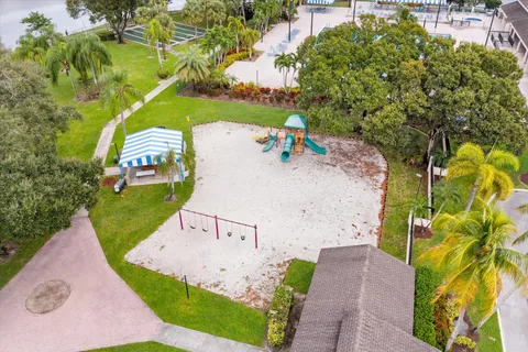 an aerial view of a house with a yard basket ball court and outdoor seating