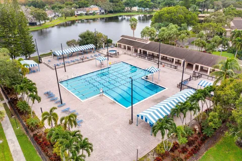an aerial view of a house with outdoor space and lake view