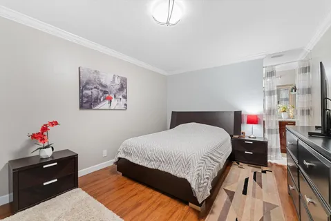 a bedroom with a bed and a chandelier