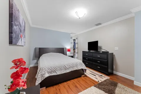 a bedroom with a bed and a television