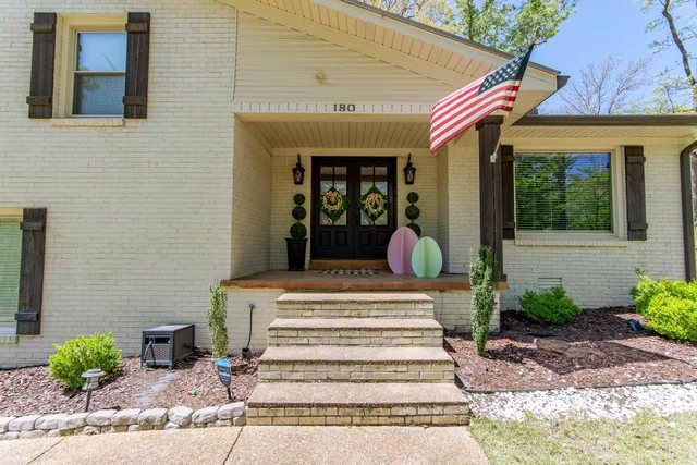 a front view of a house with potted plants