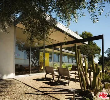 a view of a patio with table and chairs and potted plants