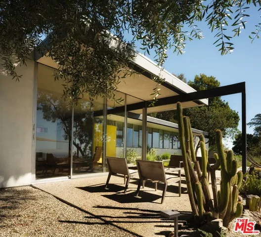 a view of a patio with table and chairs and potted plants