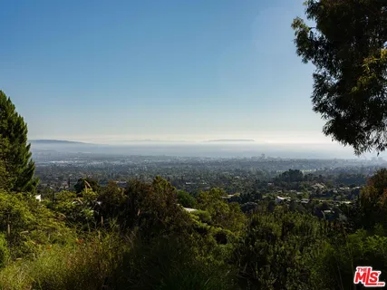 an aerial view of residential house with parking and yard