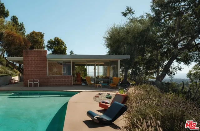 a view of a house with backyard sitting area and garden