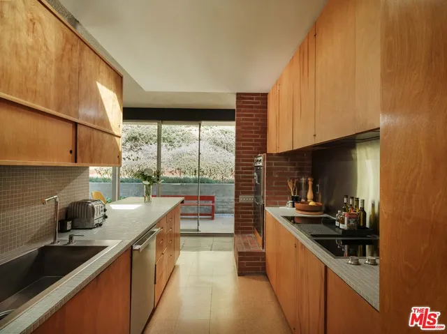 a kitchen with stainless steel appliances a sink a stove and a refrigerator