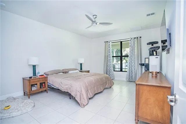 a bathroom with a granite countertop sink a mirror and shower