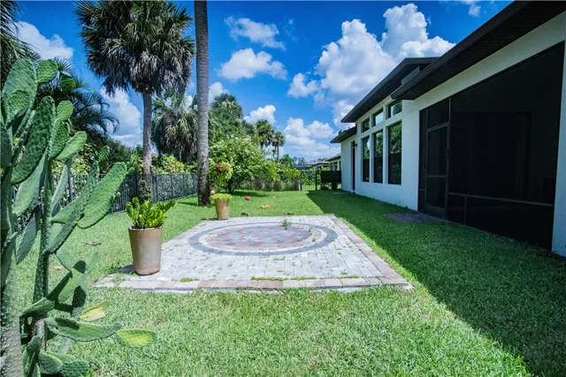 a living room with patio floor and a garden
