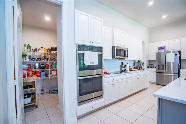 a kitchen with refrigerator and cabinets