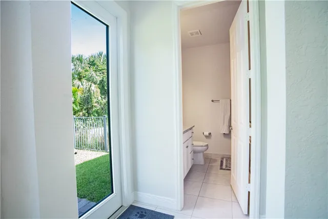 a bathroom with a granite countertop sink toilet and mirror