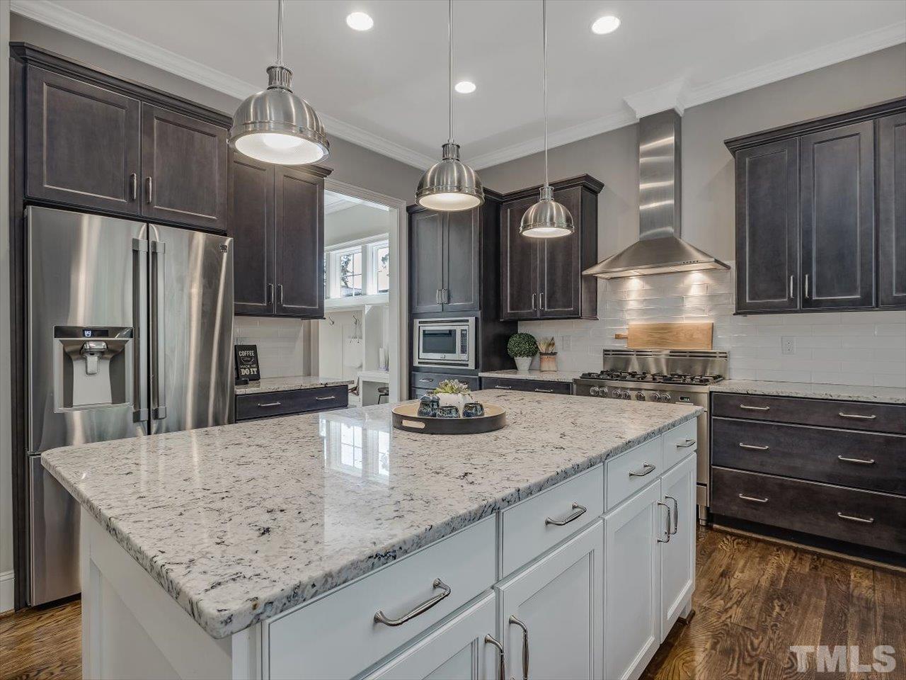 6427 Rosny Road Raleigh, NC 27613 - Photo 21 of 53 a kitchen with granite countertop a sink stainless steel appliances and cabinets