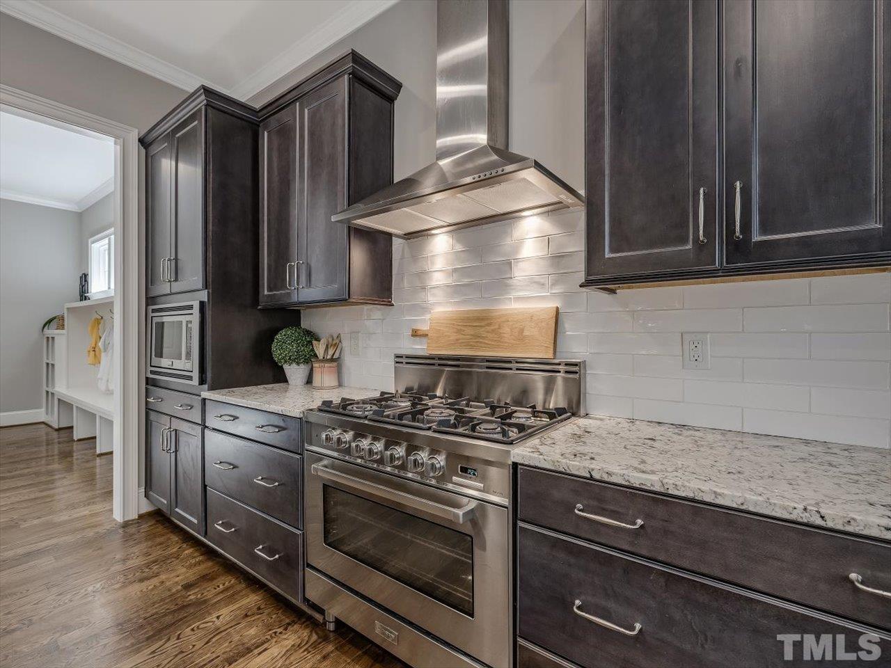 6427 Rosny Road Raleigh, NC 27613 - Photo 22 of 53 a kitchen with granite countertop a stove and a cabinets