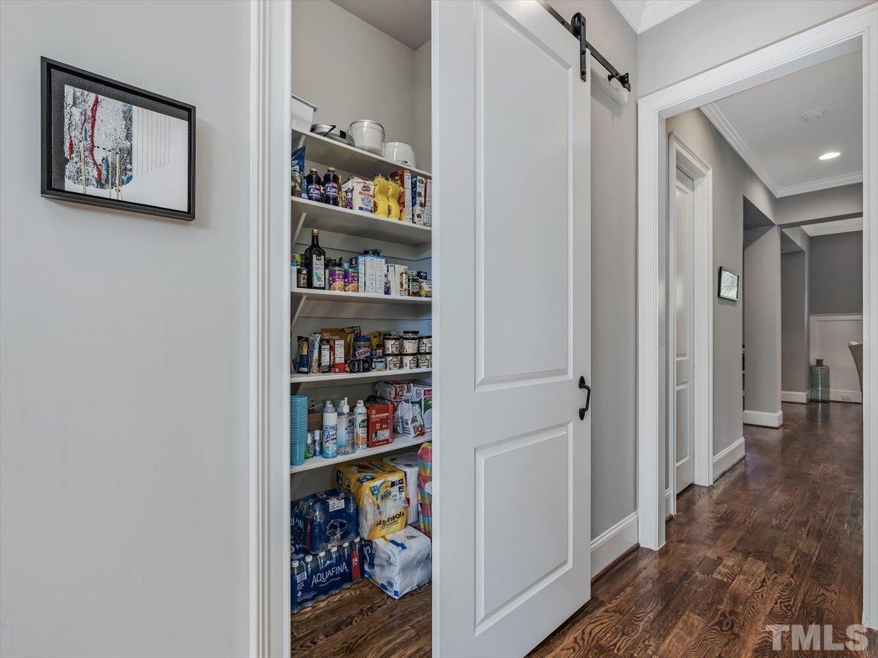 6427 Rosny Road Raleigh, NC 27613 - Photo 26 of 53 a view of a hallway with bookshelf and shelf