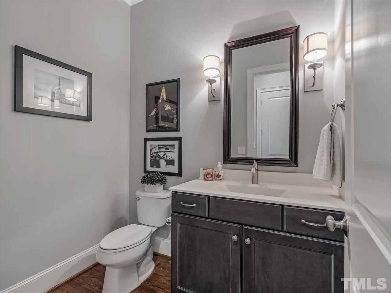 6427 Rosny Road Raleigh, NC 27613 - Photo 28 of 53 a bathroom with a toilet sink and mirror