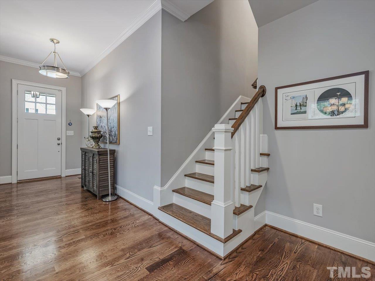 6427 Rosny Road Raleigh, NC 27613 - Photo 29 of 53 a view of a hallway with wooden floor and workspace