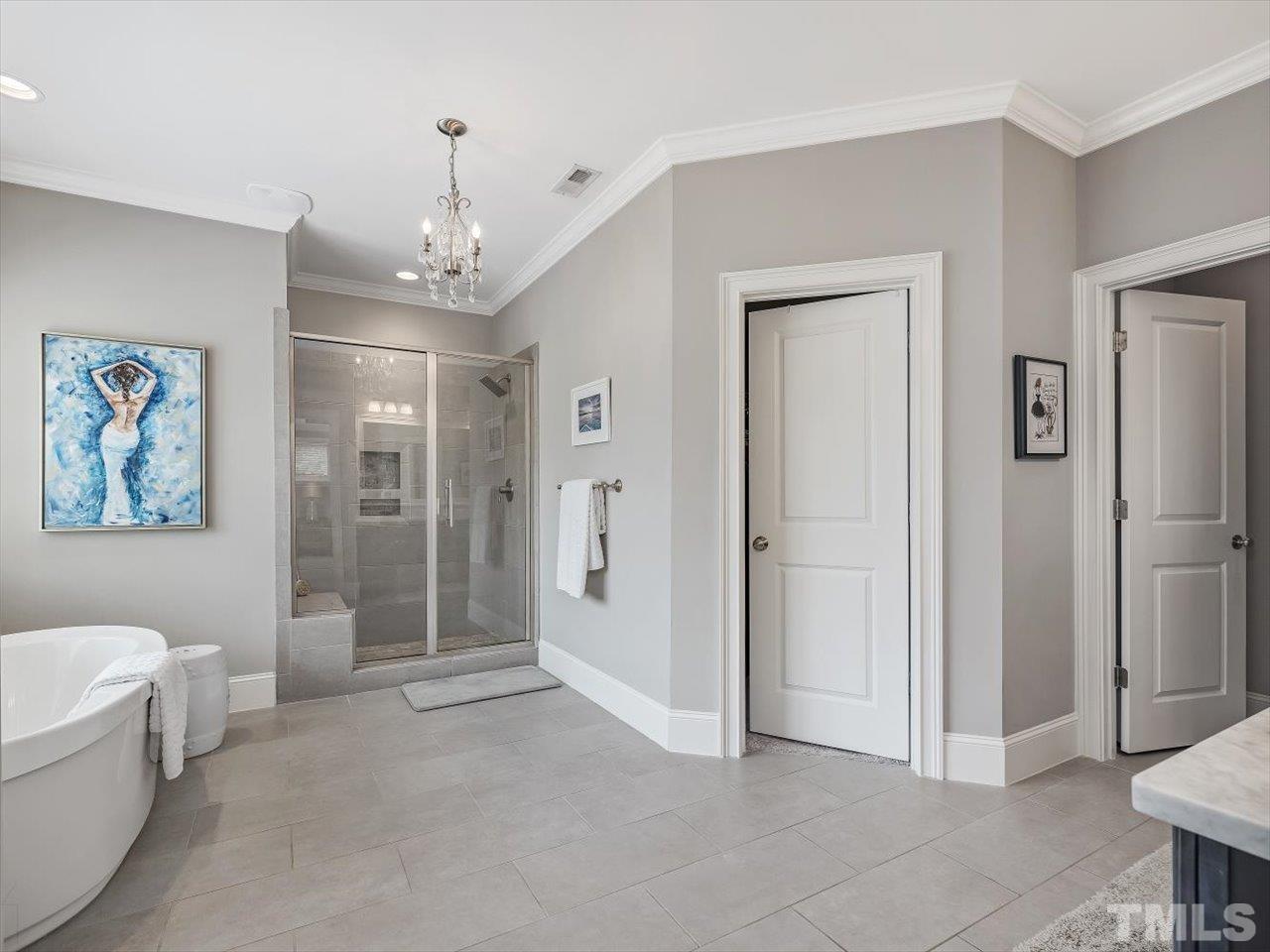 6427 Rosny Road Raleigh, NC 27613 - Photo 34 of 53 a view of a spacious bathroom with a tub shower and mirror