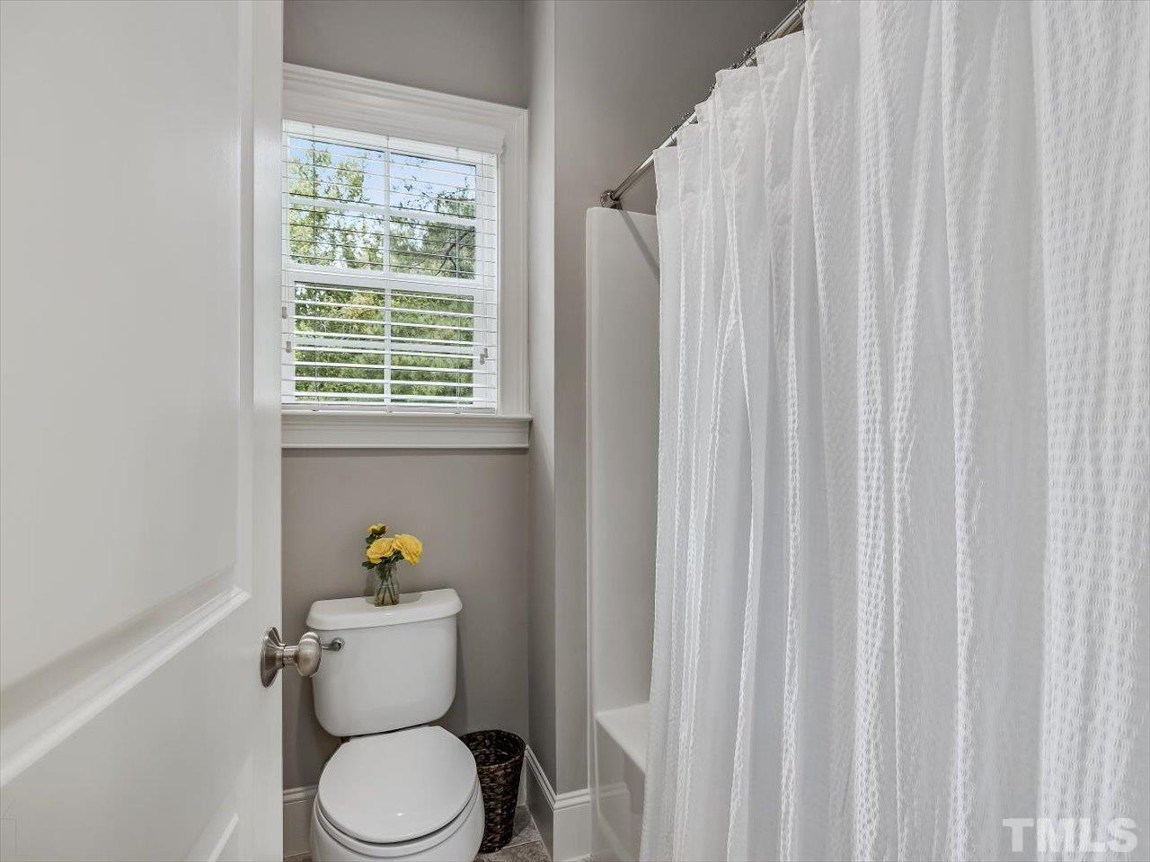 6427 Rosny Road Raleigh, NC 27613 - Photo 42 of 53 a white toilet sitting next to a window