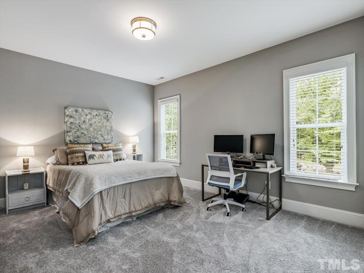 6427 Rosny Road Raleigh, NC 27613 - Photo 43 of 53 a bedroom with a bed and a desk