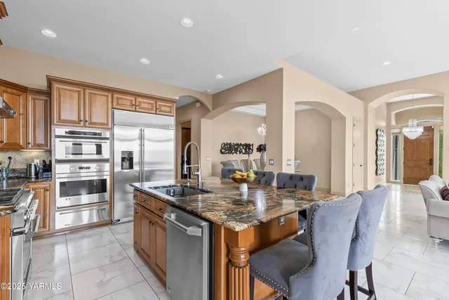 a kitchen with granite countertop a sink and cabinets