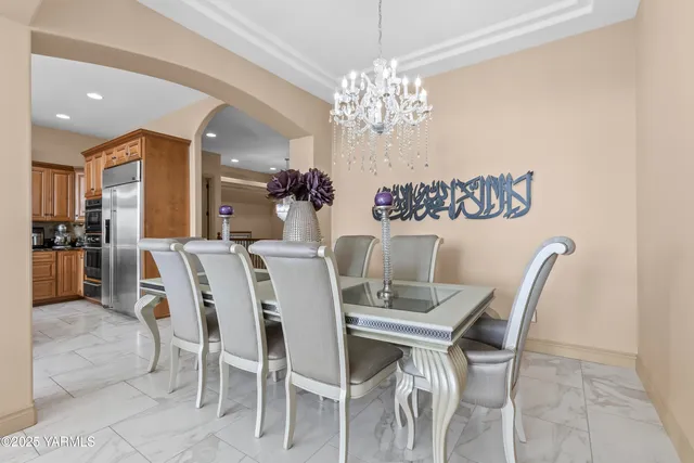 a view of a dining room with furniture and chandelier