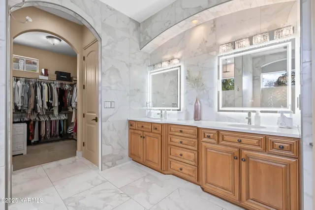 a spacious bathroom with a granite countertop sink a mirror and a