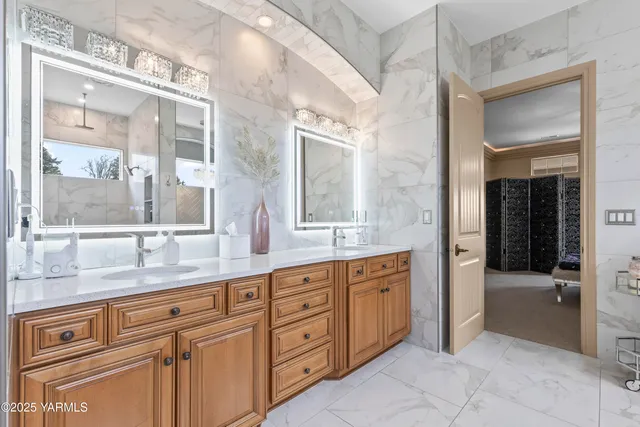 a bathroom with a granite countertop sink mirror and