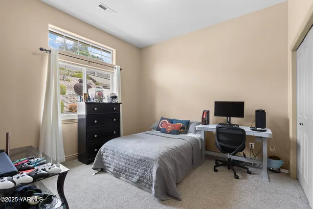 a bedroom with a bed and a window