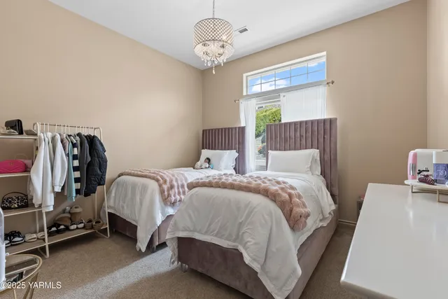 a bedroom with a bed and a chandelier