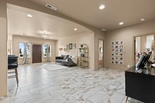 a lobby with furniture and a dining table