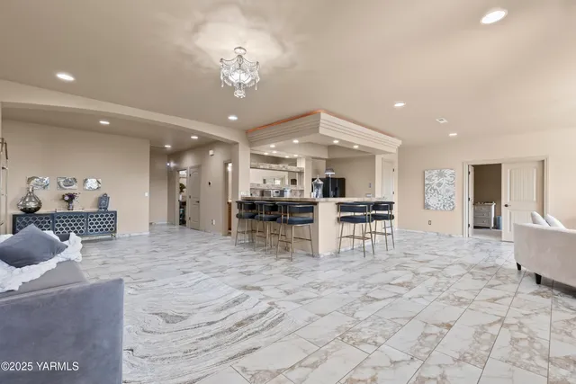 a kitchen with stainless steel appliances kitchen island granite countertop a table and chairs