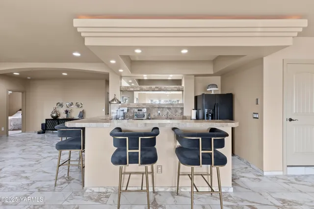 a kitchen with a refrigerator and furniture