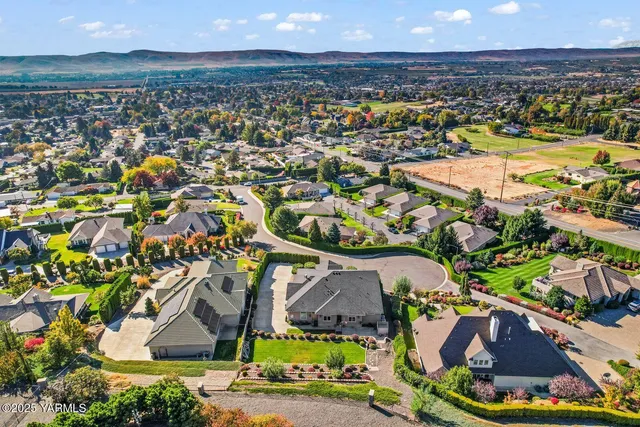 an aerial view of residential houses with outdoor space