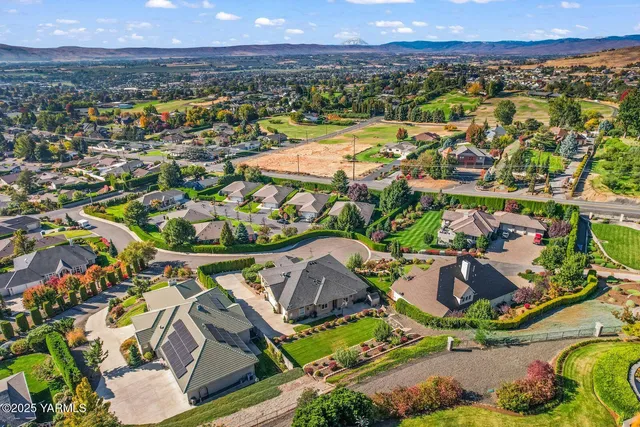 an aerial view of residential houses with outdoor space and swimming pool