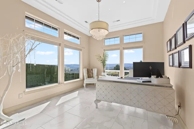 a living room with fireplace furniture and a large window