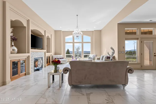 a living room with fireplace furniture and a flat screen tv