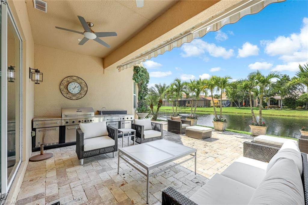 6582 Monterey Point Naples, FL 34105 - Photo 27 of 27 a living room with patio furniture and a large window