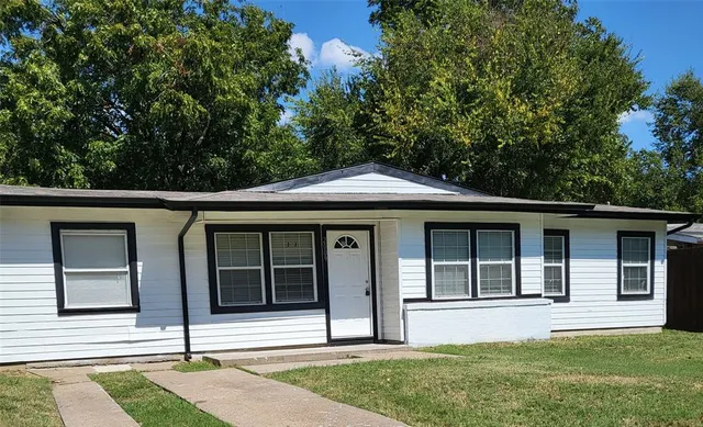 a house that has a tree in front of it