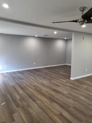 an empty room with wooden floor
