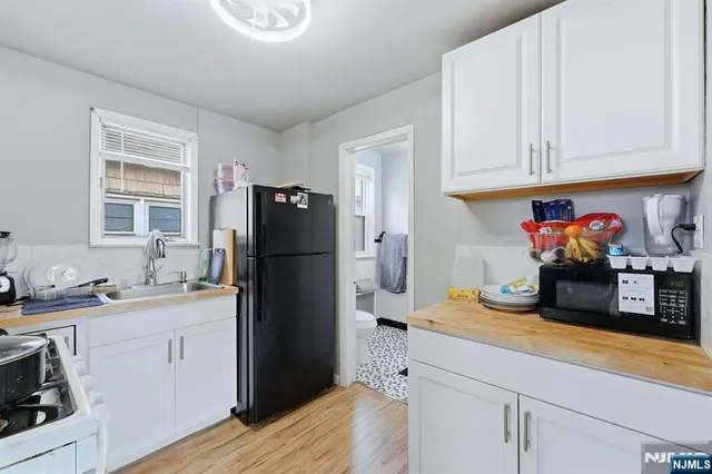 a kitchen with stainless steel appliances granite countertop a refrigerator sink and cabinets